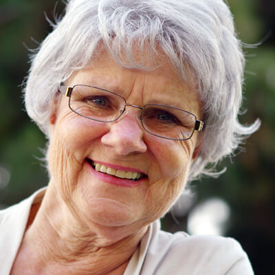 Woman with fixed dentures smiling.